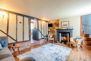 A cozy living room with exposed wooden beams, a fireplace, and a comfortable seating area. - 1 Bed in Halesworth (oc-p44724) (Halesworth)