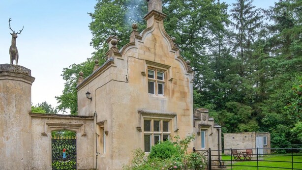 A historic stone building with a traditional architectural style, featuring a prominent entrance gate and a deer statue. - 1 Bed in Exton (oc-e42799) (Exton)