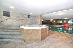 A hot tub with a geometric tile design, a pool, and a staircase leading to a higher level. - 3 Bed in Berrier (oc-o44951) (Hutton)