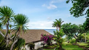 A house with a tiled roof, surrounded by a well-maintained garden with various plants and a view of the ocean. - Villa Eden Roc in BANYUNING,  AMED,  ABANG, (BANYUNING,  AMED,  ABANG,)