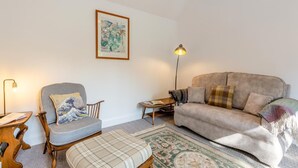 A living room with a sofa, armchair, and a small table with a lamp. - 1 Bed in Rathmell (oc-w44883) (Gisburn Forest)