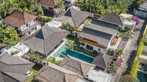 A residential area with multiple houses, a central swimming pool, and surrounding greenery. - Villa Hoi in Seminyak (Seminyak)