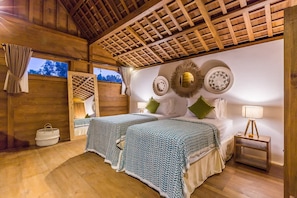 A wooden room with a bed, bedside tables, and a window. - Villa Hoi in Seminyak (Seminyak)