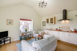 A compact living space with a kitchenette, a dining area, and a seating area with a television. - 1 Bed in Chaigley (oc-c44973) (Aighton, Bailey and Chaigley)