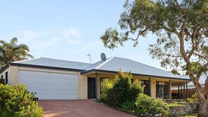 A residential house with a garage, a satellite dish, and a paved driveway. - Augusta Views Family Retreat (Augusta)
