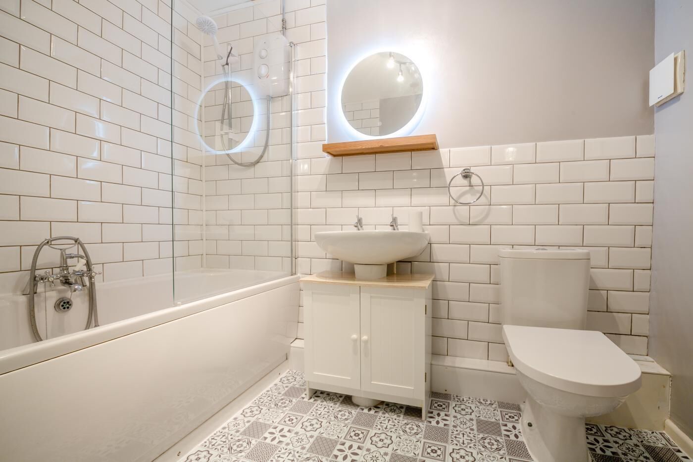 A bathroom with a bathtub, a sink, a toilet, and a shower.