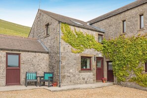 A stone building with two windows, a door, and a bench outside. - 1 Bed in Earl Sterndale (oc-s44819) (Earl Sterndale)