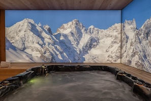 A hot tub with a mountain view.