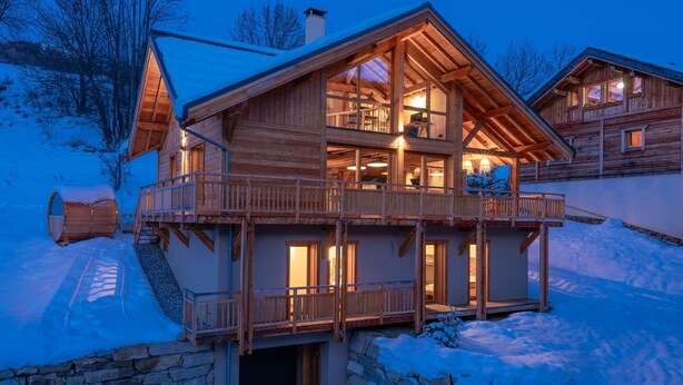 A wooden chalet with a balcony, stone foundation, and multiple windows. - Chalet Le Refuge - Five Bedroom House, Sleeps 14 (La Salle-les-Alpes)