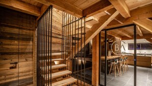 A wooden staircase with a glass door leading to a kitchen area with bar stools. - Beleza - Seven Bedroom House, Sleeps 15 (La Salle-les-Alpes)