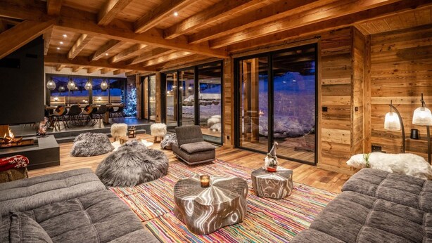 A cozy living room with a fireplace, comfortable seating, and a large window offering a view of the snowy landscape. - Beleza - Seven Bedroom House, Sleeps 15 (La Salle-les-Alpes)