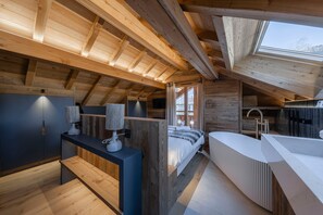 A modern loft bedroom with a skylight, a built-in bed, a vanity, and a bathroom. - Galibier - Five Bedroom House, Sleeps 13 (Chantemerle)