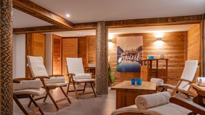 A spa room with wooden walls, a large painting, and multiple lounge chairs. - Le Stam - Seven Bedroom House, Sleeps 15 (La Salle-les-Alpes)