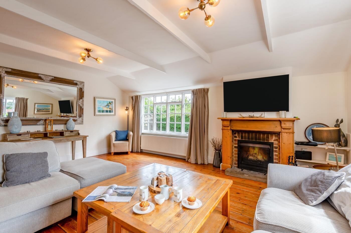 A spacious living room with a fireplace, a television, and a comfortable seating area.
