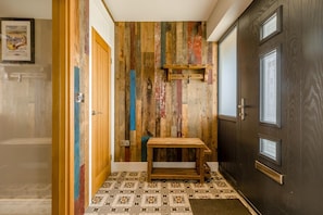 A hallway with a wooden wall, a door, and a tiled floor. - 4 Bed in Old Hunstanton (oc-o44907) (Hunstanton)