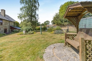 A stone house with a wooden deck and a pergola. - 4 Bed in Newchurch (oc-bow333) (Newchurch)
