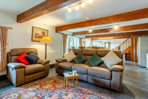 A living room with a brown leather sofa, a matching armchair, and a patterned rug. - 2 Bed in Thornton Rust (oc-t45331) (Thornton Rust)