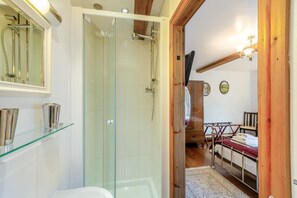 A bathroom with a glass shower enclosure, a toilet, and a sink with a glass shelf. - 2 Bed in Thornton Rust (oc-t45331) (Thornton Rust)