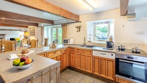 A kitchen with wooden cabinets, a built-in microwave, a sink, and a stove. - 2 Bed in Thornton Rust (oc-t45331) (Thornton Rust)