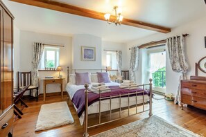 A bedroom with a bed, bedside tables, a dresser, a window with curtains, and a chandelier. - 2 Bed in Thornton Rust (oc-t45331) (Thornton Rust)