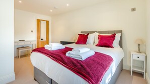 A hotel room with a bed, bedside table, lamp, and a desk with a chair. - 4 Bed in Scorton (oc-t44226) (Scorton)