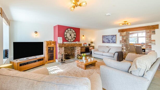 A living room with a television, a fireplace, a sofa, and a coffee table. - 4 Bed in Scorton (oc-t44226) (Scorton)