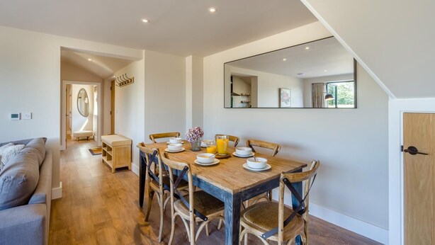 A dining area with a wooden table, chairs, and a breakfast setting. - 2 Bed in Bardwell (oc-d44861) (Bardwell)