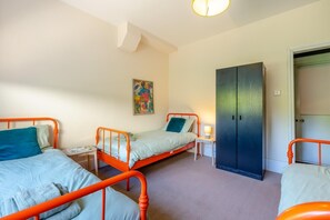 A bedroom with two beds, a wardrobe, a bedside table, and a wall-mounted artwork. - 2 Bed in Eastbourne (oc-e44809) (Eastbourne)