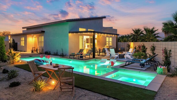 A modern house with a swimming pool, outdoor seating, and a well-maintained garden. - Your Own Private Luxe Brand New Resort (Bermuda Dunes)
