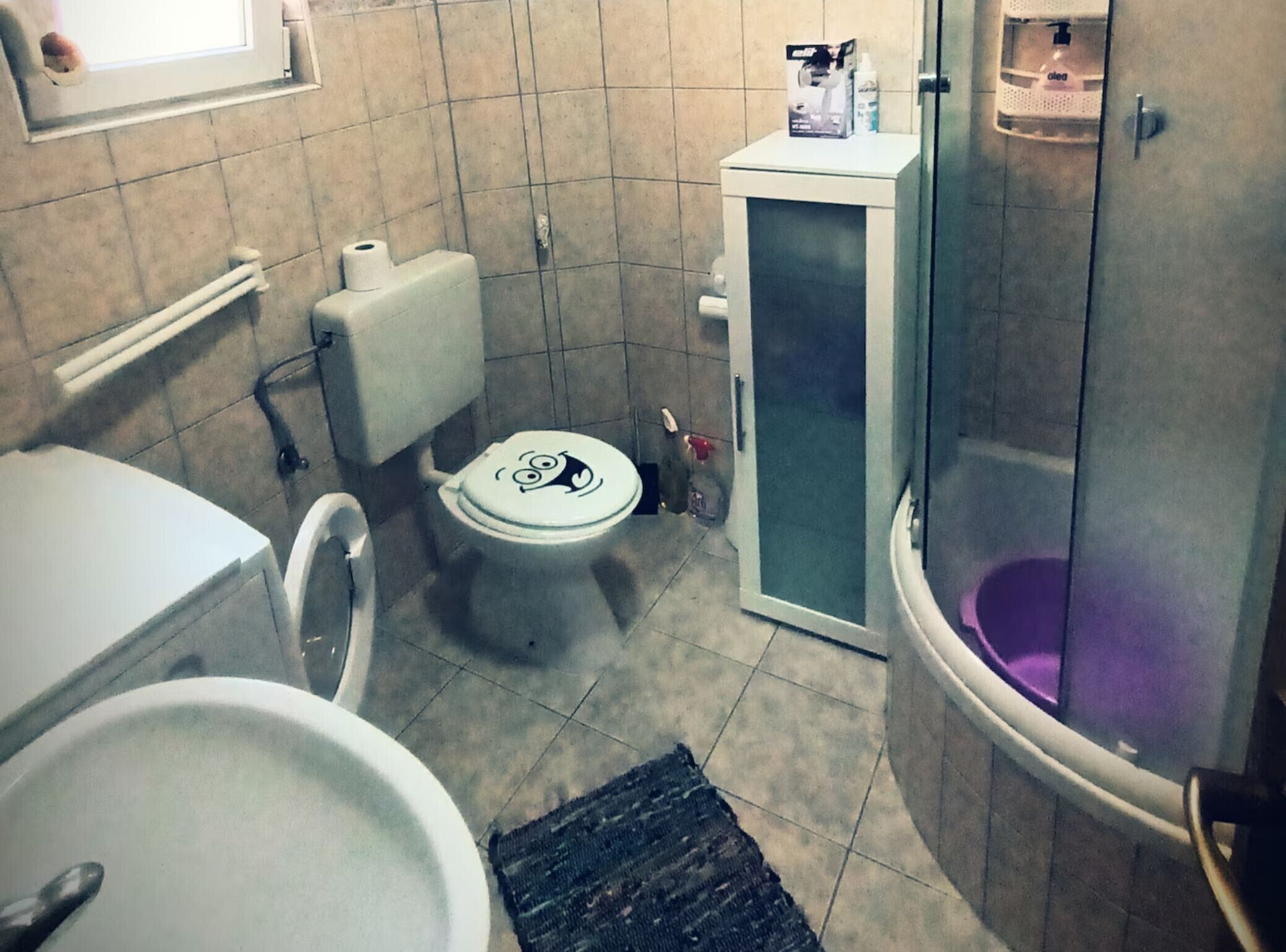 A bathroom with a toilet, bidet, and shower.