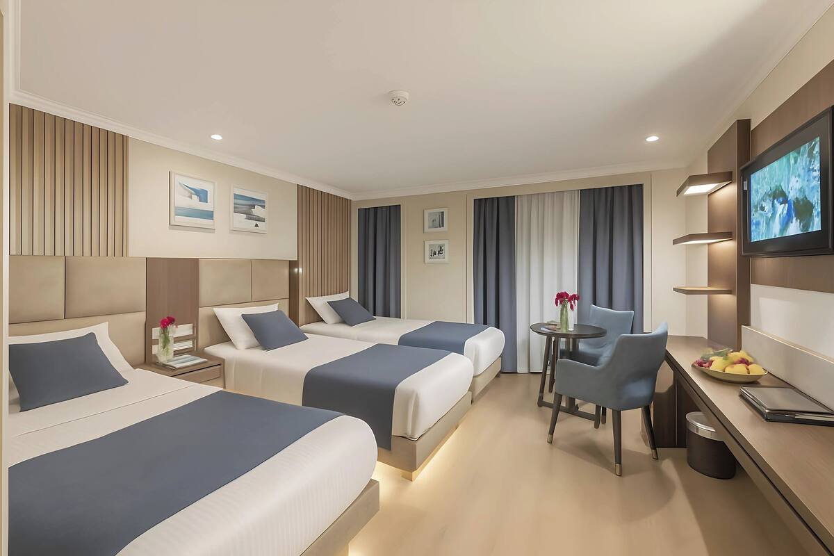 Deluxe Triple Room, River View | In-room safe, blackout drapes