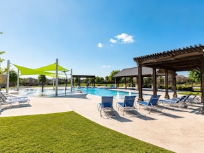 A swimming pool with lounge chairs, a covered area, and a grassy lawn. - Peaceful Escape | Backyard | Community Pool & Park (Midlothian)