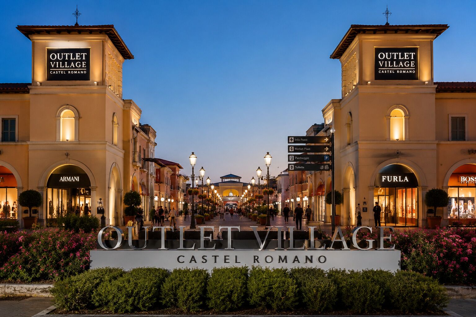 A sign for Outlet Village Castel Romano with shops like Armani and Furla.