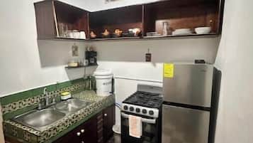 Coffee/tea maker, fridge, oven, cookware/dishes/utensils