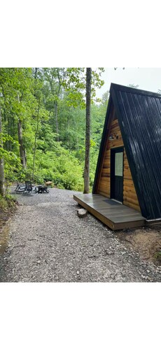 The Naturalists is a peaceful off grid A frame cabin with an outdoor shower.
