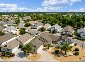A residential area with houses, roads, and a clear sky.