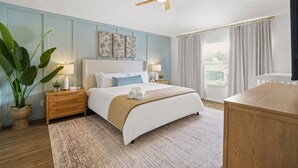 A bedroom with a bed, bedside tables, a nightstand, a ceiling fan, a window with curtains, and a potted plant. - House of Wonder ✨ Theatre • Theme Rooms • Arcade • Pool • Minutes to Disney (Kissimmee)