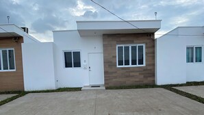 A modern residential building with a flat roof, a central entrance, and a paved driveway. - La nueva San Migue is a  safe place ,w 2  bedrooms, pool ,restaurants near, (San Miguel)