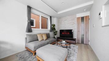 Apartment | Living area | 50-inch flat-screen TV with digital channels