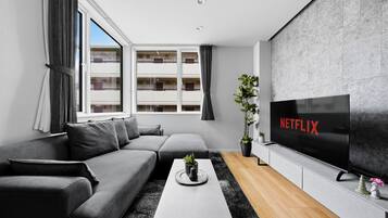 Apartment | Living area | 50-inch flat-screen TV with digital channels