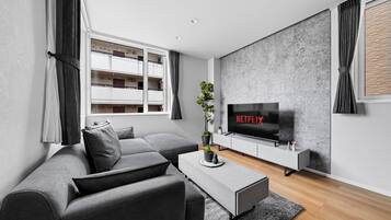 Apartment | Living area | 50-inch flat-screen TV with digital channels