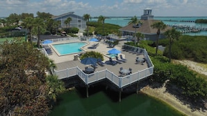 A resort with a pool, lounge chairs, umbrellas, and a view of the ocean. - 2BR, 2BA Boca Grande condo with ocean views. (Boca Grande)
