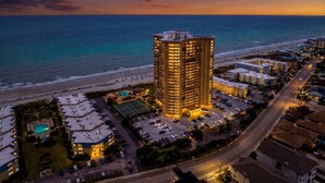 A high-rise hotel with a pool and tennis court, located near a beach and a road. - Stunning Oceanview Retreat | Onsite Dining and Sauna | M609 (Myrtle Beach)