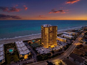 A high-rise hotel with a pool and tennis court, located near a beach and a road. - Stunning Oceanview Retreat | Onsite Dining and Sauna | M609 (Myrtle Beach)