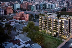 A modern multi-story building with balconies, surrounded by other buildings and a road. - Fantastic 1-bedroom+SofaBed - 3 People apartment in Bogotá-perfect for your stay (Bogotá, D.C.)