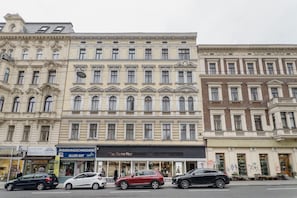 A multi-story building with a classical architectural style, featuring ornate facades and multiple windows. - Blueground | Margareten, w/d, nr Naschmarkt (Vienna)
