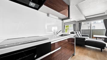 A modern kitchen with a built-in dishwasher, a sink, and wooden cabinets.