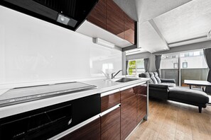 A modern kitchen with a built-in dishwasher, a sink, and wooden cabinets. - NOBLE 201 (Sapporoshi)