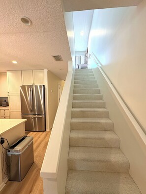 A modern kitchen with a stainless steel refrigerator, a built-in oven, and a dishwasher. - Spacious 3-bedroom townhome in Ocean Gallery in St. Augustine steps to pool (St. Augustine)
