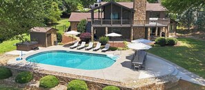 A residential property with a swimming pool, a covered patio, and a stone exterior. - Completely Renovated - Ideal for up to 16 with private pool, hot tub, arcade and great amenities! (Denver)